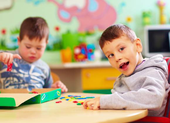 Two pre-school children playing in educational setting.