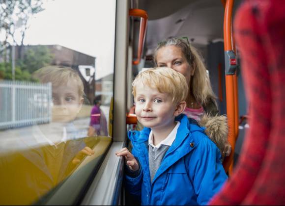 Young person and carer using public transport.