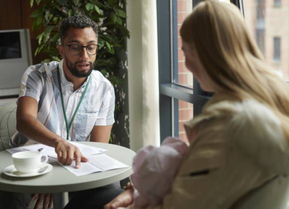 Professional person in meeting with carer.